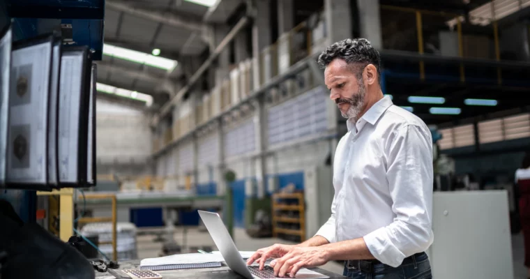 man looking at ERP training services on a laptop