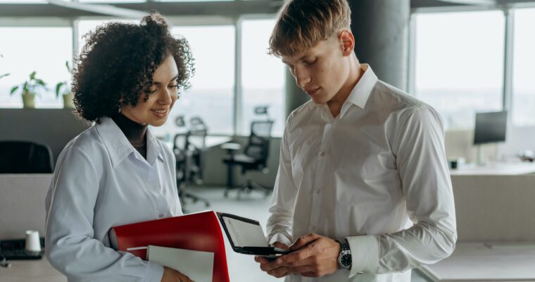 woman and man discussing statutory annual financial statements in office