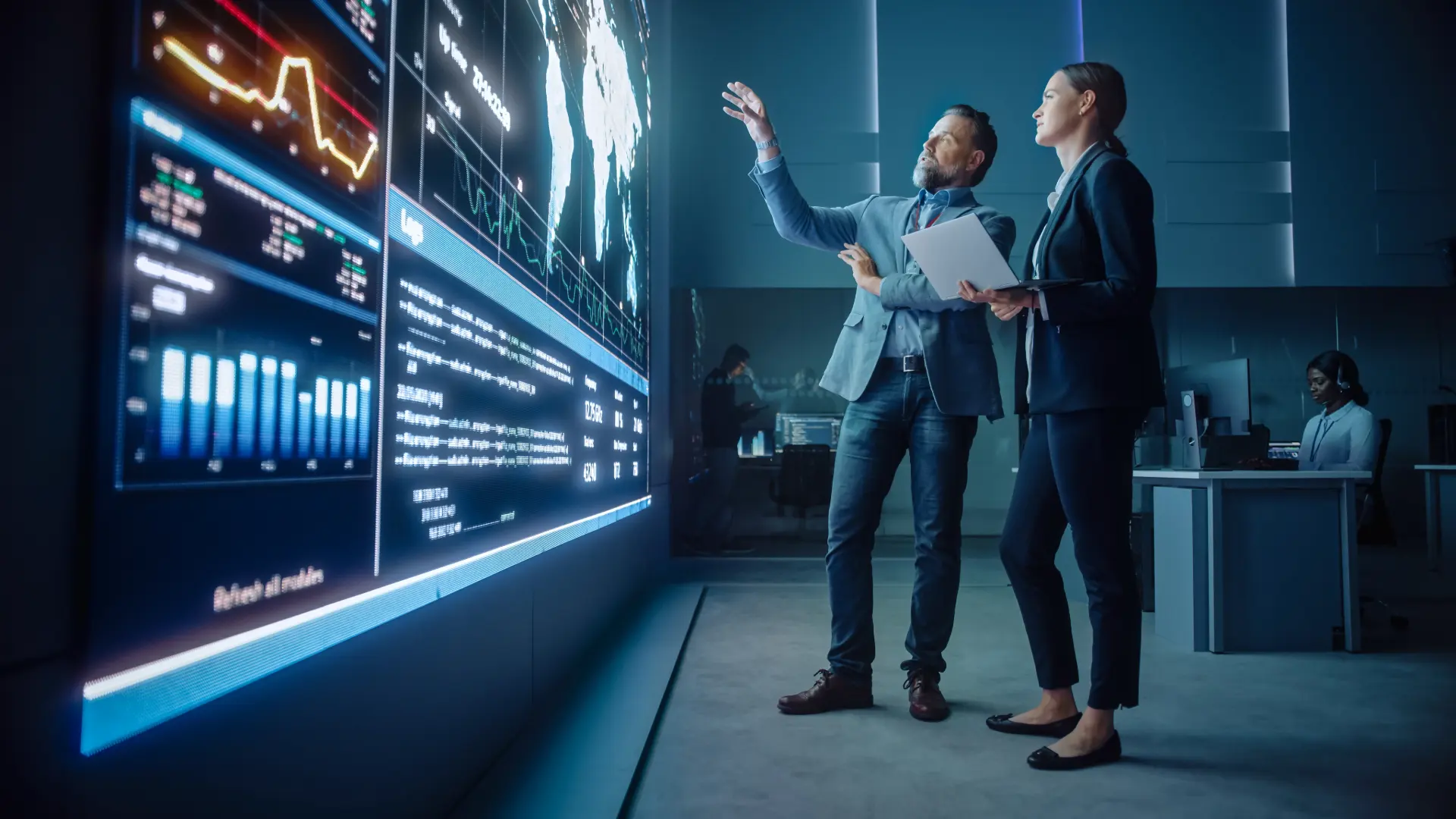 man and woman discussing on building an automated and scalable business at a screen with information